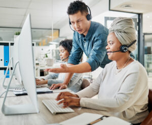 Man helps woman with small business computer support