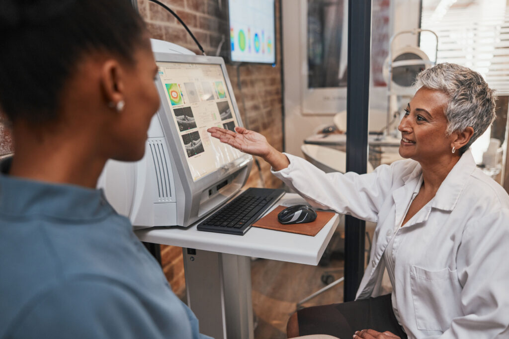 Smiling woman using computer pointing at something