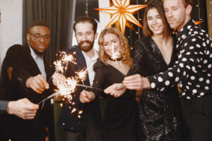 Coworkers lighting sparklers for the new year